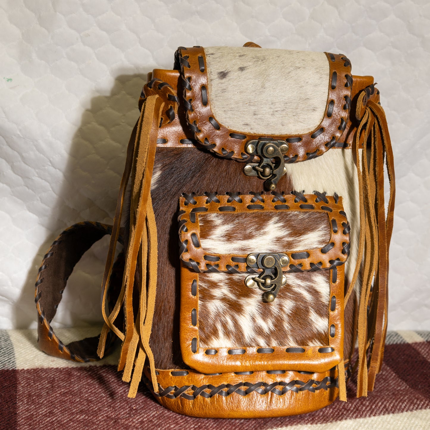 #100 BACKPAK / BRASS CLOSURE ON FRONT POCKET WITH LEATHER LACING