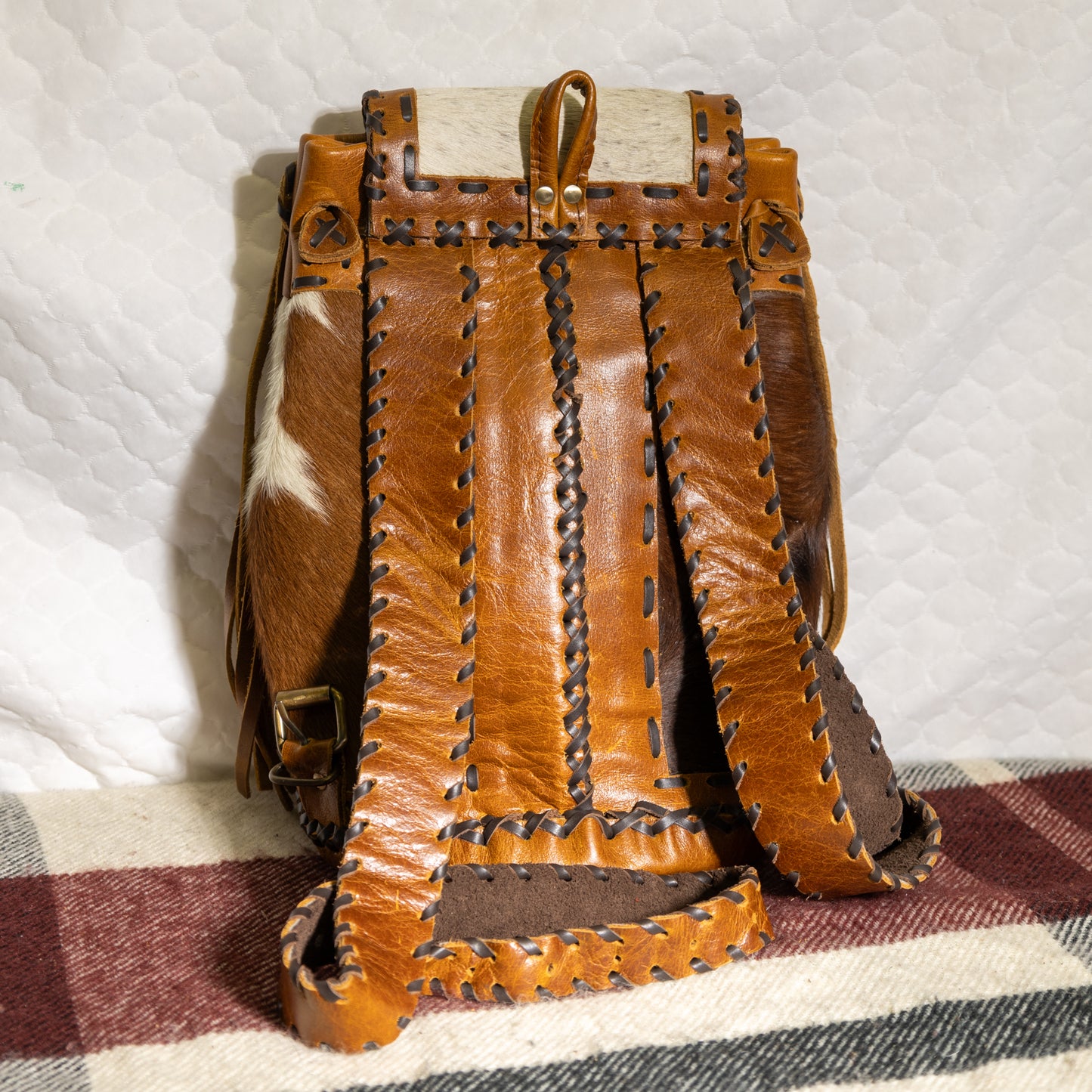 #100 BACKPAK / BRASS CLOSURE ON FRONT POCKET WITH LEATHER LACING