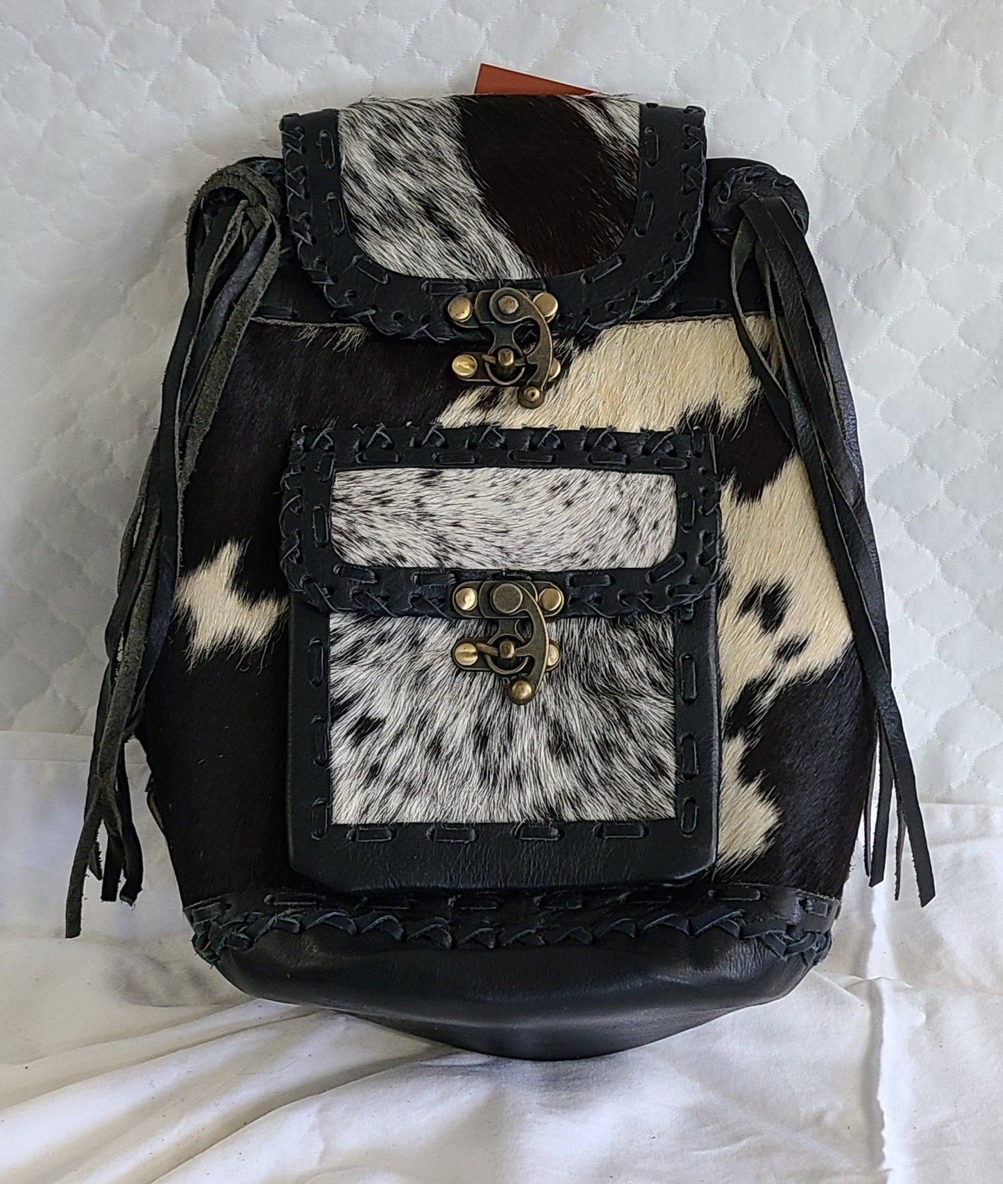 #100 BACKPAK / BRASS CLOSURE ON FRONT POCKET WITH LEATHER LACING